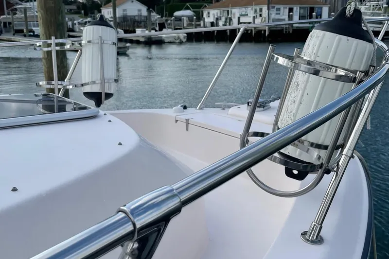 Slide: The Image of 2005 Grady-White Marlin 300 boat deck with railing and dock view. - 5