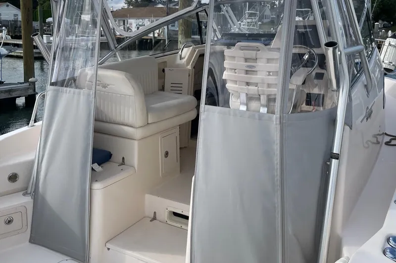 Slide: The Image of 2005 Grady-White Marlin 300 boat interior with seating and clear protective covers. - 7