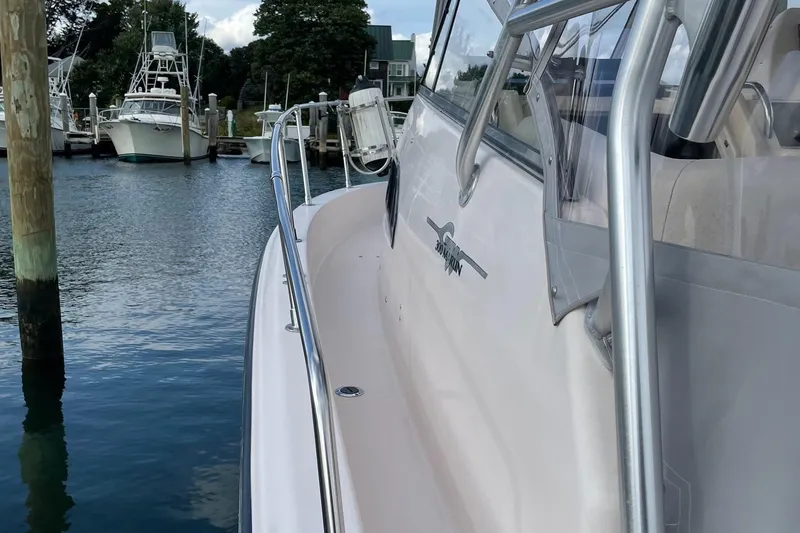 Slide: The Image of 2005 Grady-White Marlin 300 boat docked in a marina, side view. - 8