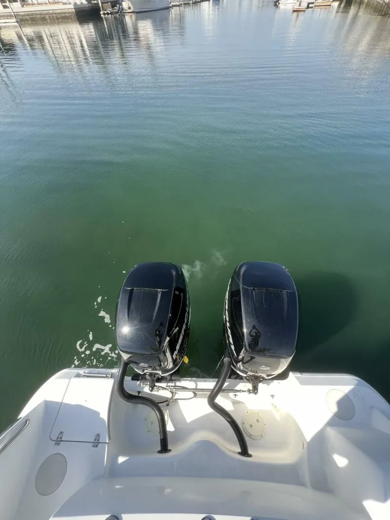 Slide: The Image of 2012 Boston Whaler 320 Outrage with dual outboard motors on calm water. - 15