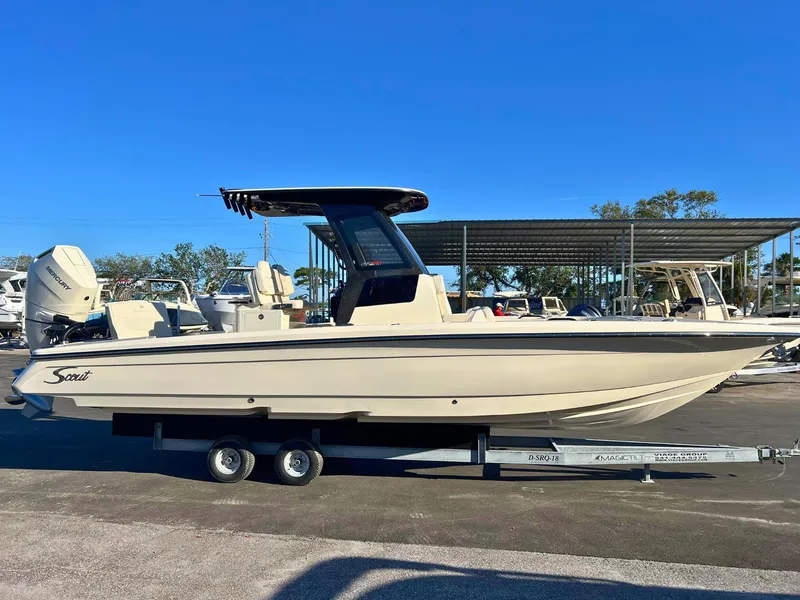 The Image of 2025 Scout 281 XSS boat on trailer, side view under clear blue sky. - 0