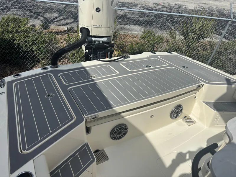 Slide: The Image of 2025 Scout 281 XSS boat deck with motor, featuring sleek design and modern amenities. - 10