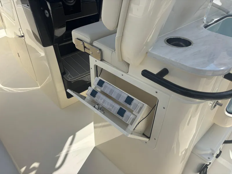 Slide: The Image of 2025 Scout 281 XSS boat interior with storage compartment and seating. - 11