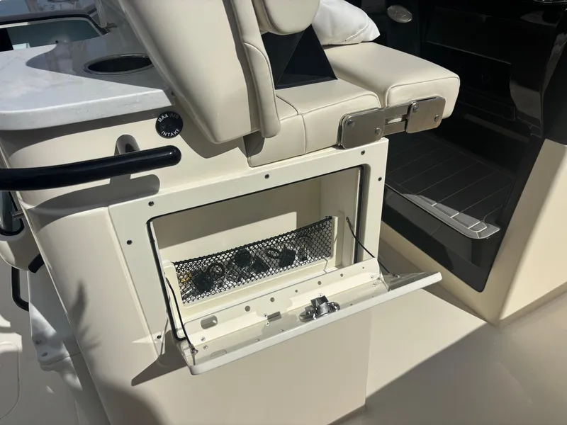 Slide: The Image of 2025 Scout 281 XSS boat interior storage compartment with seating. - 12