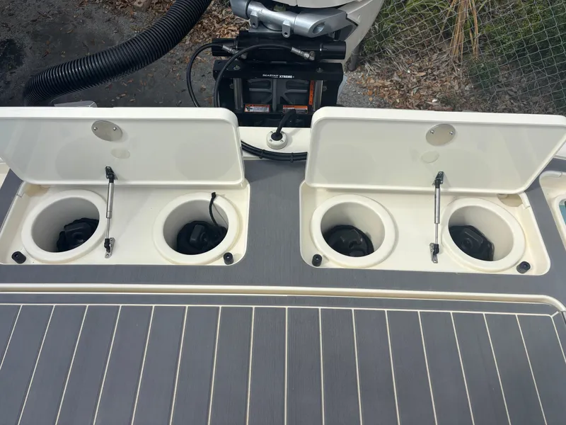 Slide: The Image of 2025 Scout 281 XSS boat with open storage compartments on deck. - 14