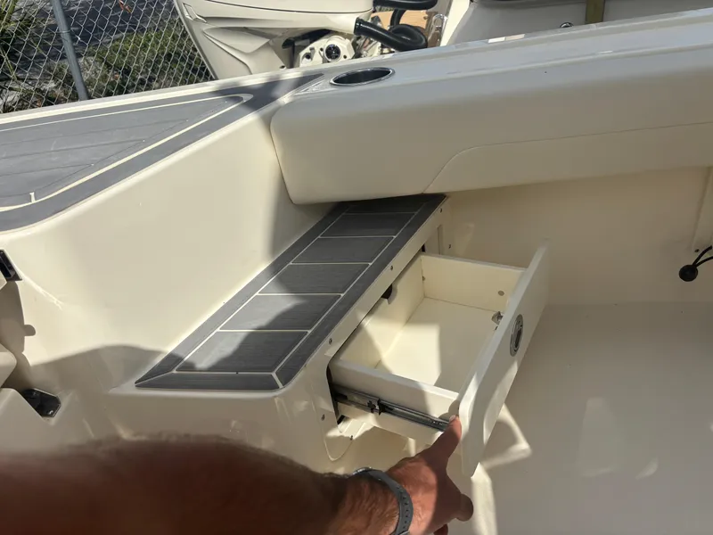 Slide: The Image of 2025 Scout 281 XSS boat interior with open storage compartment. - 15