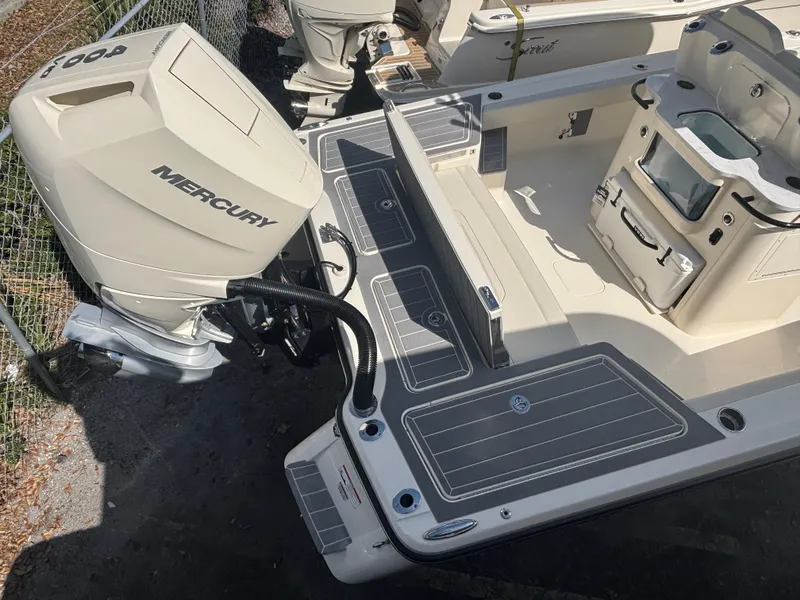 Slide: The Image of 2025 Scout 281 XSS boat with Mercury engine, featuring spacious deck and modern design. - 2