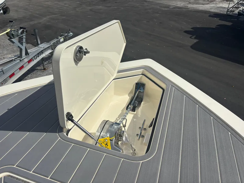 Slide: The Image of 2025 Scout 281 XSS boat anchor compartment open on deck. - 20