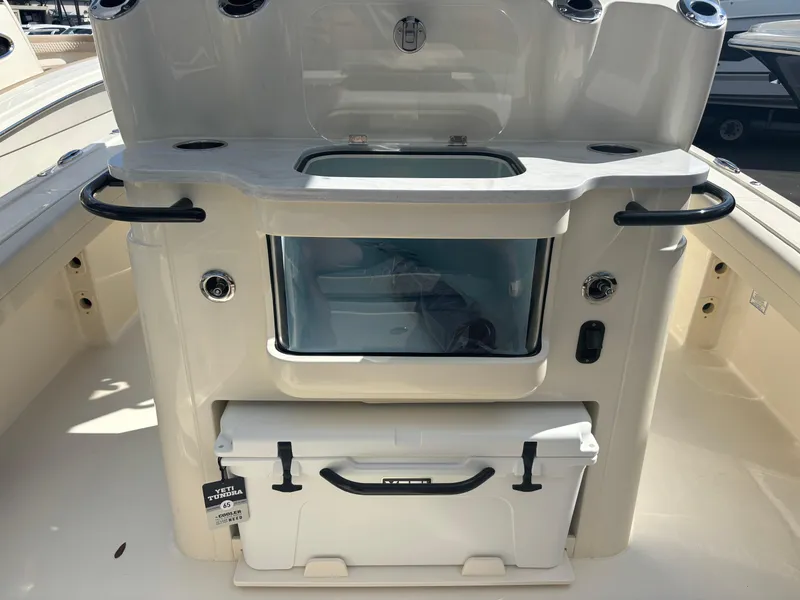 Slide: The Image of 2025 Scout 281 XSS boat interior with storage and cooler. - 4