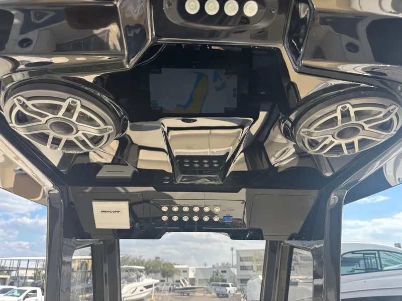 Slide: The Image of 2025 Scout 281 XSS boat interior with advanced audio system and navigation display. - 6