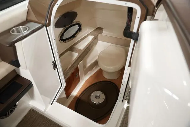 Slide: The Image of 2016 Formula Boats 290 Bowrider interior cabin with toilet and porthole. - 20