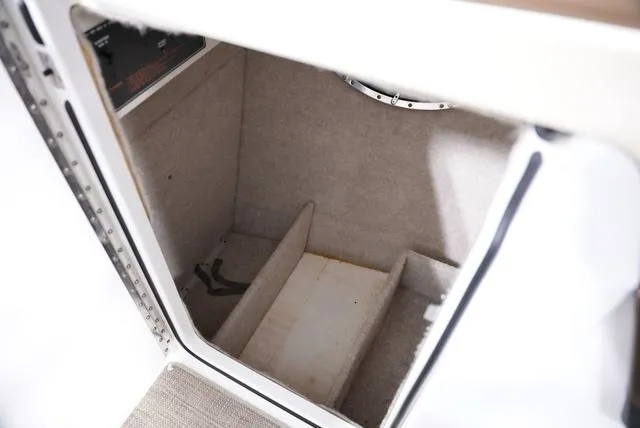 Slide: The Image of Interior storage compartment of 2016 Formula Boats 290 Bowrider, featuring carpeted walls and shelving. - 21