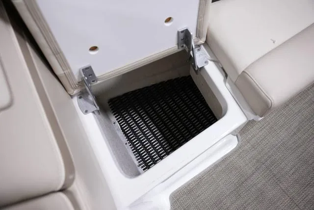Slide: The Image of 2016 Formula Boats 290 Bowrider storage compartment with open lid and black mat inside. - 24