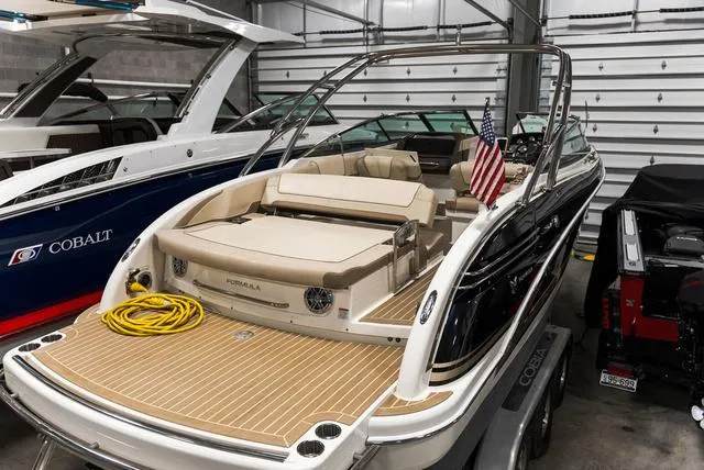 Slide: The Image of 2016 Formula Boats 290 Bowrider in storage, featuring sleek design and American flag. - 4
