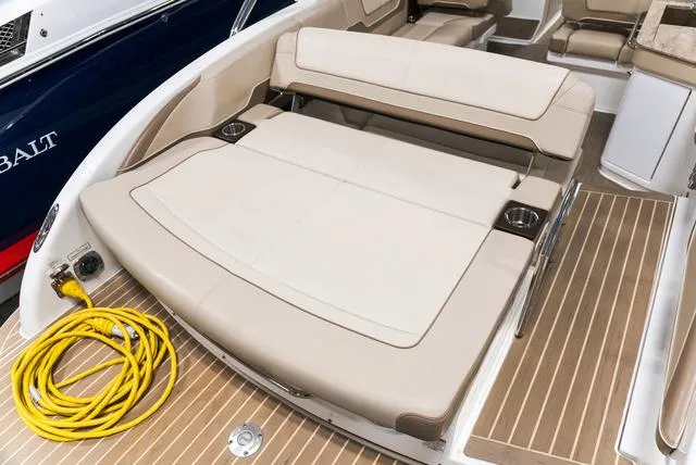Slide: The Image of 2016 Formula Boats 290 Bowrider interior with beige seating and wooden deck. - 6