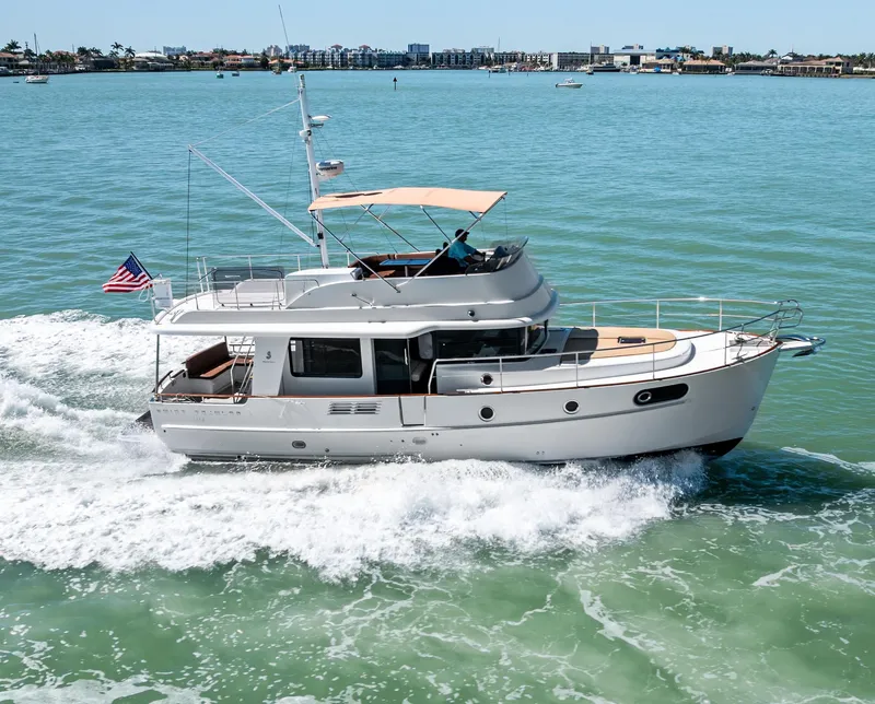 Slide: The Image of 2012 Beneteau Swift Trawler 44 cruising on open water, showcasing sleek design and performance. - 0