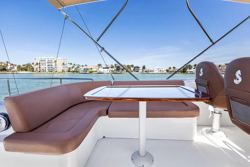 Slide: The Image of Luxurious seating area on 2012 Beneteau Swift Trawler 44 with scenic waterfront view. - 11