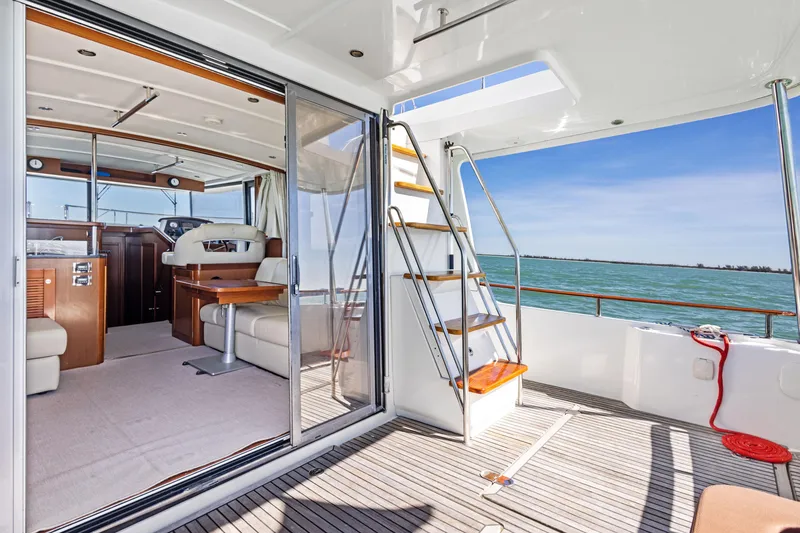 Slide: The Image of 2012 Beneteau Swift Trawler 44 interior with ocean view, showcasing elegant design and spacious layout. - 12