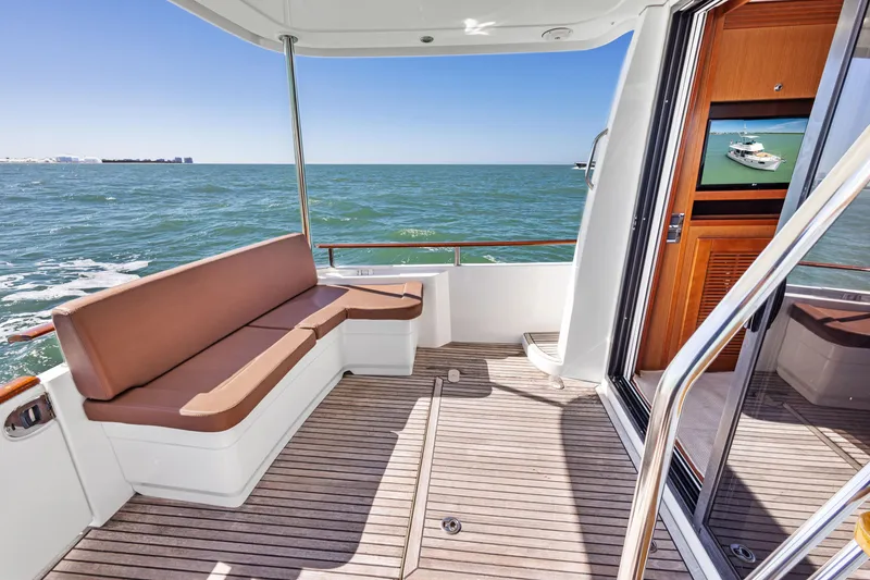 Slide: The Image of 2012 Beneteau Swift Trawler 44 deck with ocean view and seating area. - 14