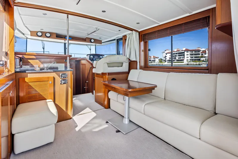 Slide: The Image of Interior of 2012 Beneteau Swift Trawler 44 with modern furnishings and panoramic windows. - 17