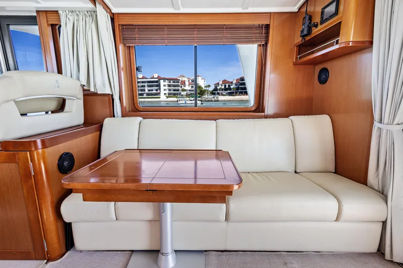 Slide: The Image of Interior of 2012 Beneteau Swift Trawler 44 with sofa and wooden table. - 18