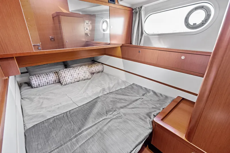 Slide: The Image of Cozy cabin interior of 2012 Beneteau Swift Trawler 44 with wood finish and bedding. - 25