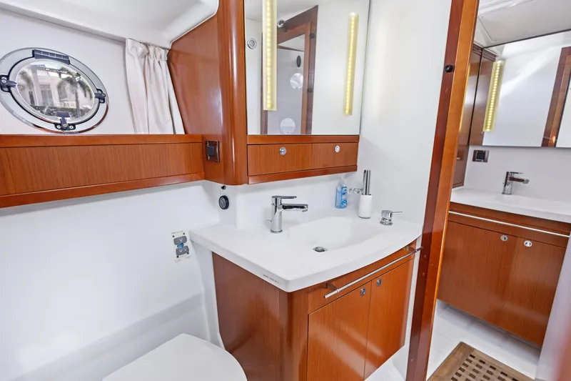 Slide: The Image of Luxurious bathroom in 2012 Beneteau Swift Trawler 44 with wood cabinetry and modern fixtures. - 26