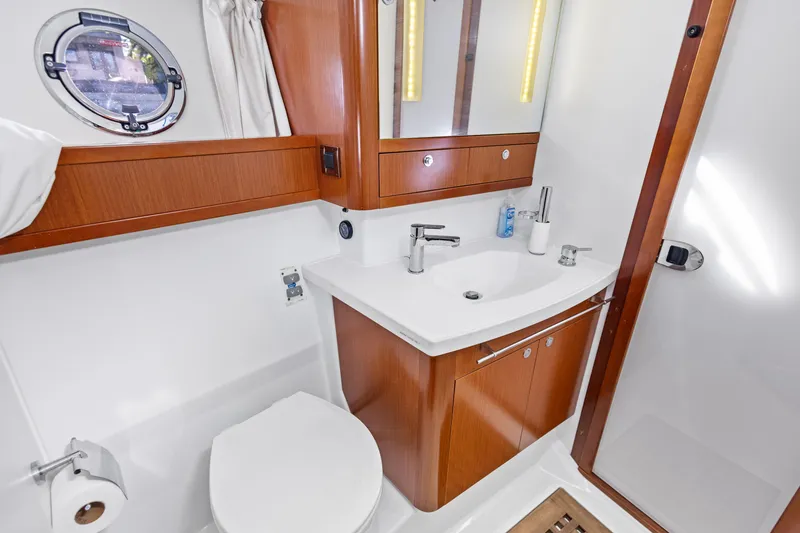 Slide: The Image of 2012 Beneteau Swift Trawler 44 bathroom with wooden cabinetry and modern fixtures. - 27