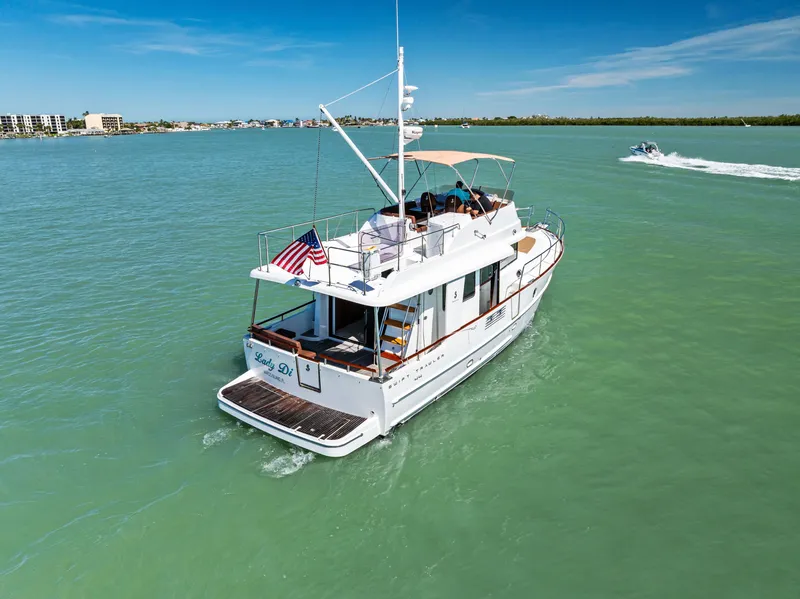 Slide: The Image of 2012 Beneteau Swift Trawler 44 cruising on turquoise waters under a clear blue sky. - 4