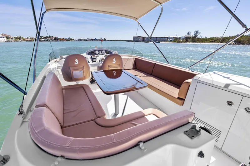 Slide: The Image of Luxurious 2012 Beneteau Swift Trawler 44 with spacious outdoor seating and scenic ocean view. - 7