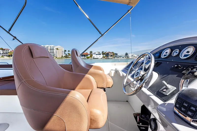 Slide: The Image of Helm of 2012 Beneteau Swift Trawler 44 with leather seats and modern controls. - 9