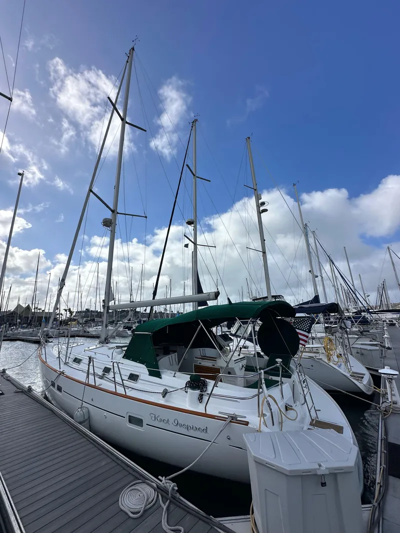 Slide: The Image of 2002 Beneteau 411 sailboat docked at marina under blue sky. - 1