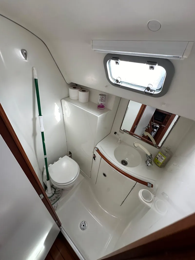 Slide: The Image of Beneteau 411 2002 yacht bathroom with sink, toilet, and window. - 41