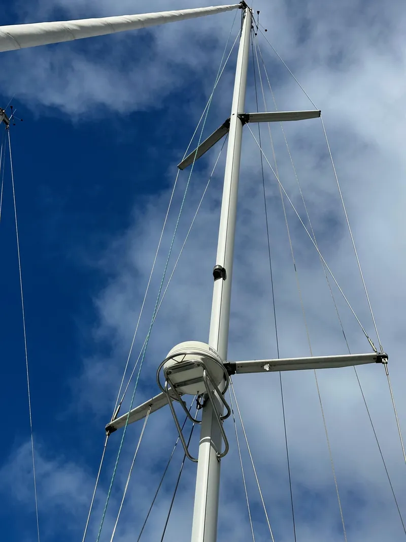 Slide: The Image of Mast of 2002 Beneteau 411 sailboat against a blue sky with clouds. - 6
