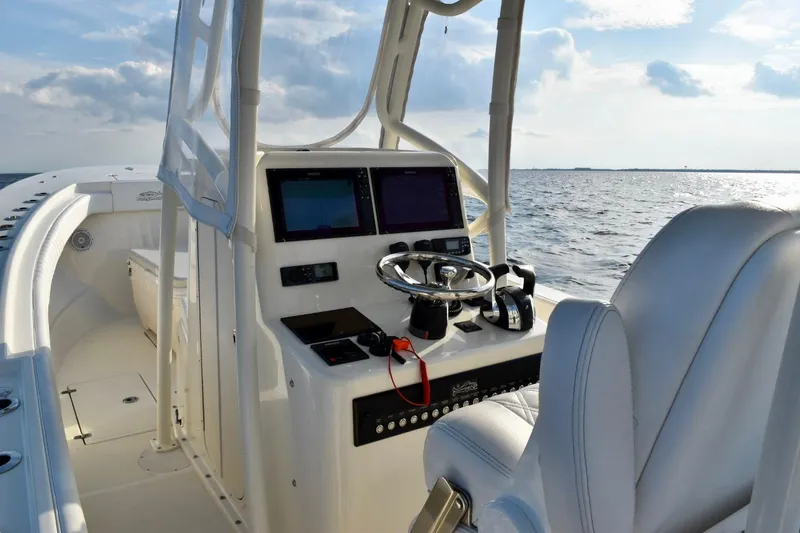 Slide: The Image of 2021 Panga Marine boat interior with steering console, ocean view, and modern navigation equipment. - 11