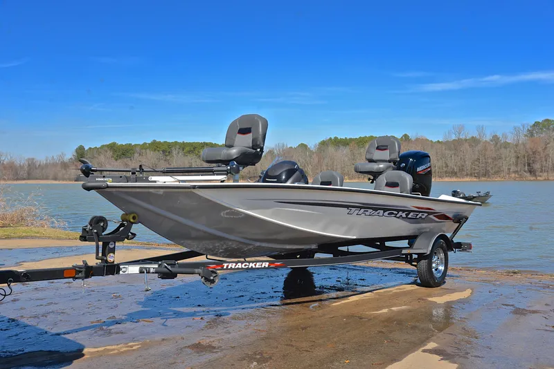Slide: The Image of 2023 Bass Tracker PRO TEAM 175 TF boat on a trailer by a lake. - 10