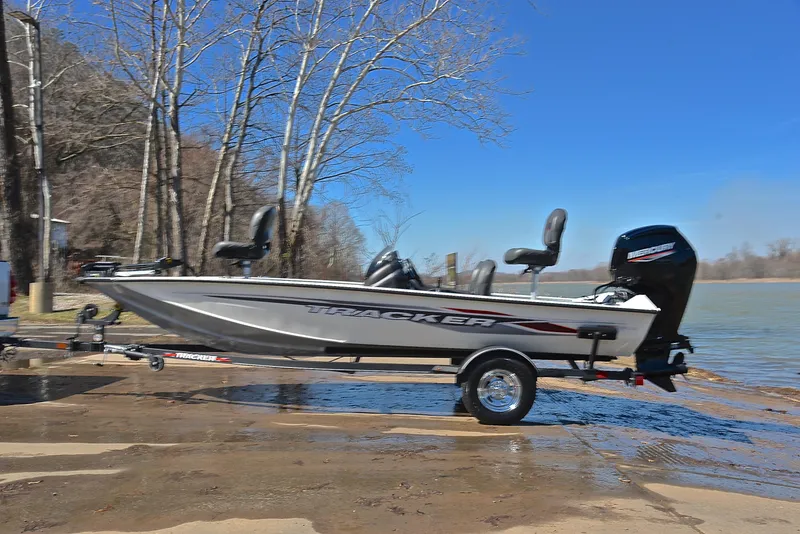Slide: The Image of 2023 Bass Tracker PRO TEAM 175 TF boat on trailer by a lake. - 11