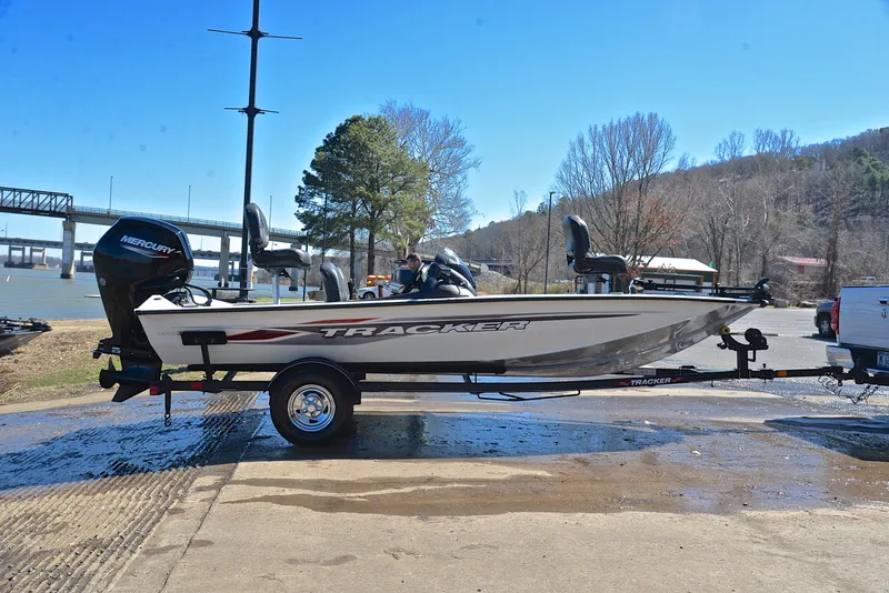 Slide: The Image of 2023 Bass Tracker PRO TEAM 175 TF boat on trailer by riverside. - 15