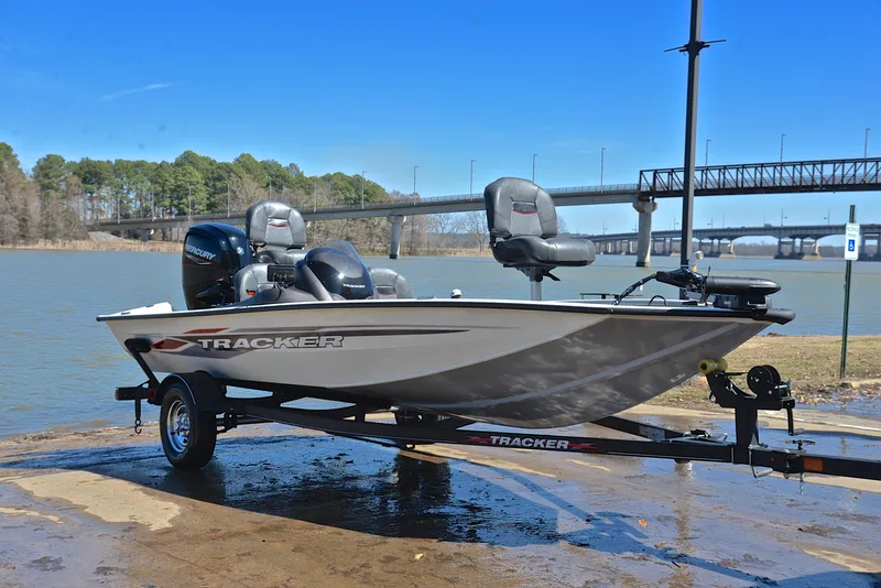 Slide: The Image of 2023 Bass Tracker PRO TEAM 175 TF boat on trailer by a lake. - 16