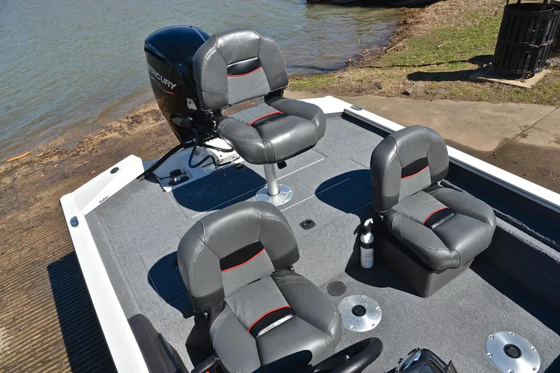Slide: The Image of 2023 Bass Tracker PRO TEAM 175 TF boat with comfortable seating near a lake. - 23