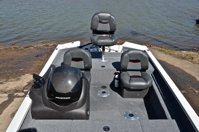 Slide: The Image of 2023 Bass Tracker PRO TEAM 175 TF boat with seating, docked by the water. - 24