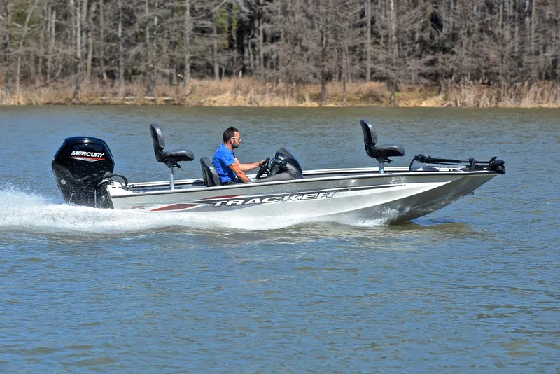 Slide: The Image of 2023 Bass Tracker PRO TEAM 175 TF boat cruising on a lake with a Mercury engine. - 3