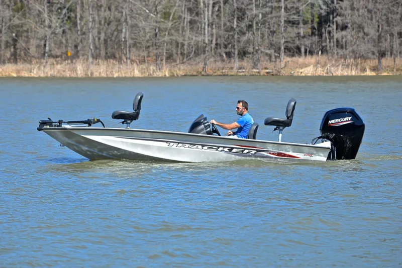 Slide: The Image of 2023 Bass Tracker PRO TEAM 175 TF boat on a lake with a person driving. - 9