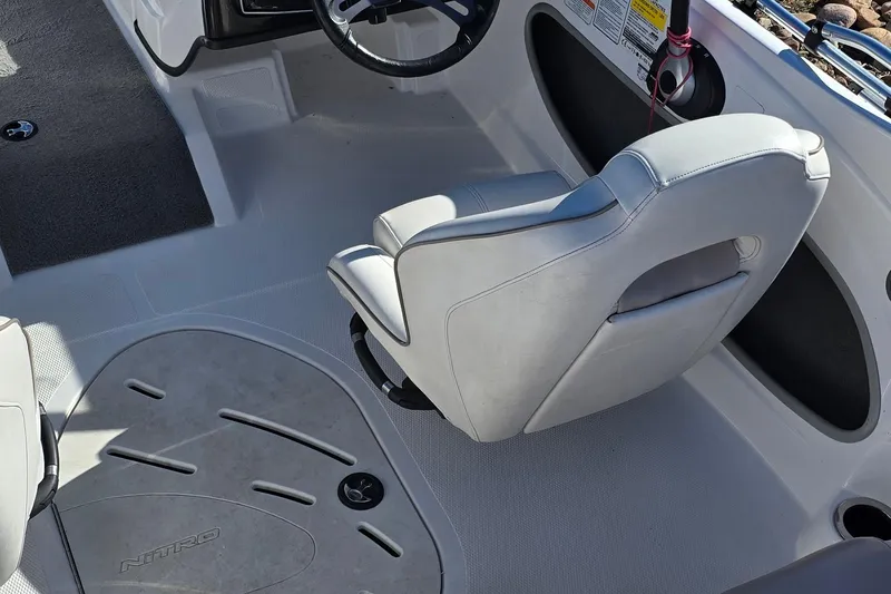 Slide: The Image of 2019 Nitro Z19 Sport boat interior with steering wheel and cushioned seat. - 70