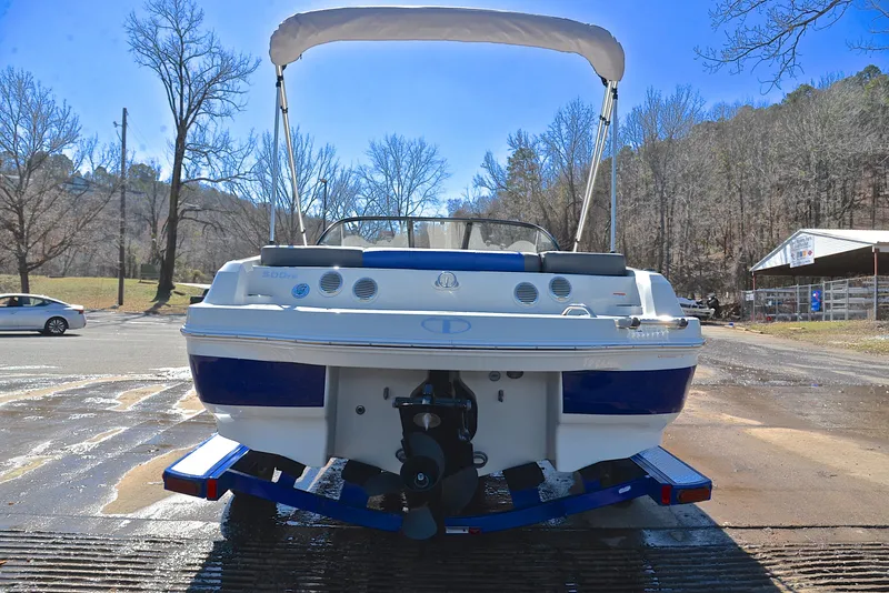 Slide: The Image of 2015 Tahoe 500 TS boat on trailer, parked outdoors with trees in the background. - 11