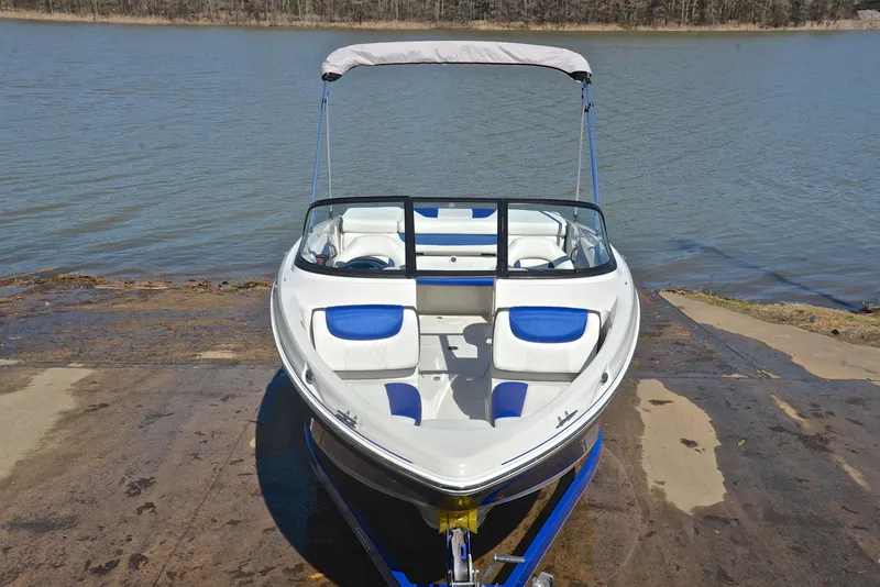 Slide: The Image of 2015 Tahoe 500 TS boat on a trailer by a lake. - 15