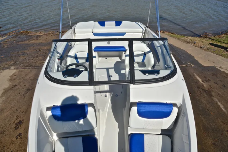 Slide: The Image of 2015 Tahoe 500 TS boat with blue and white interior, docked by the water. - 18
