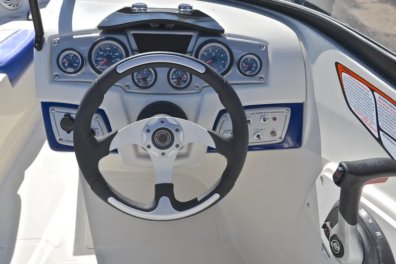 Slide: The Image of Steering console of 2015 Tahoe 500 TS boat with gauges and controls. - 23
