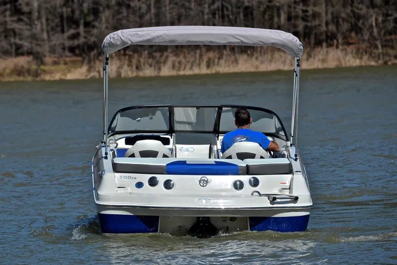Slide: The Image of 2015 Tahoe 500 TS boat cruising on a lake with a canopy. - 25