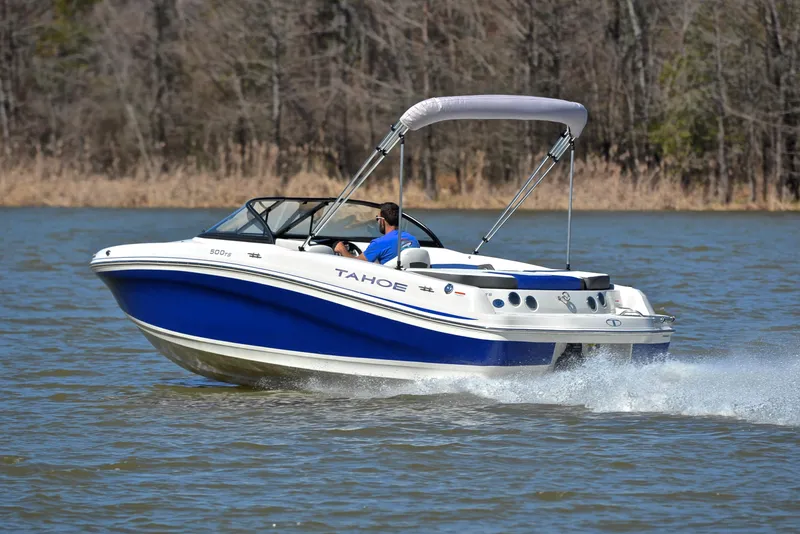 Slide: The Image of 2015 Tahoe 500 TS boat cruising on a lake with a canopy. - 4